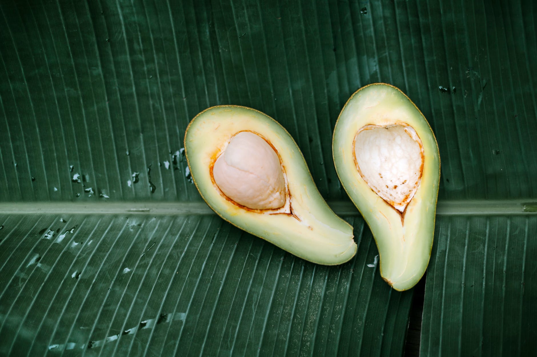 sliced avocado fruit on a banana leaf