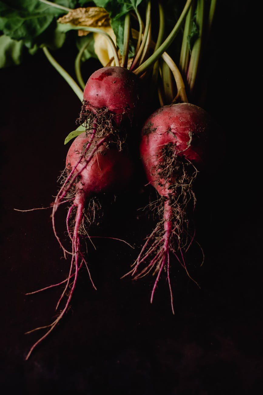 red round fruit with black background